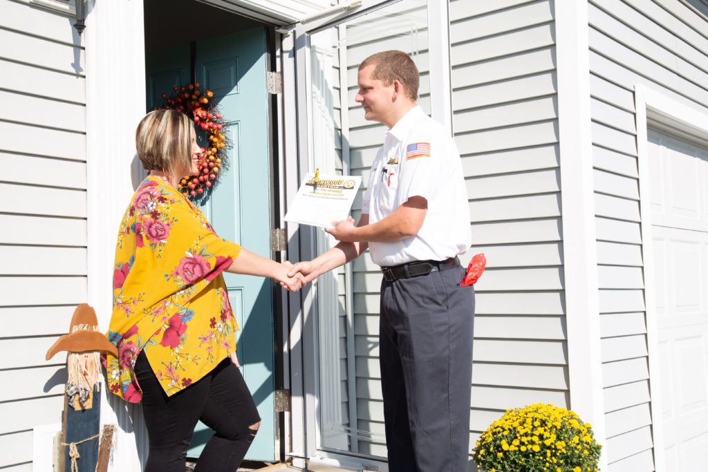 Lon Lockwood electrician shaking hands with a customer at their front door